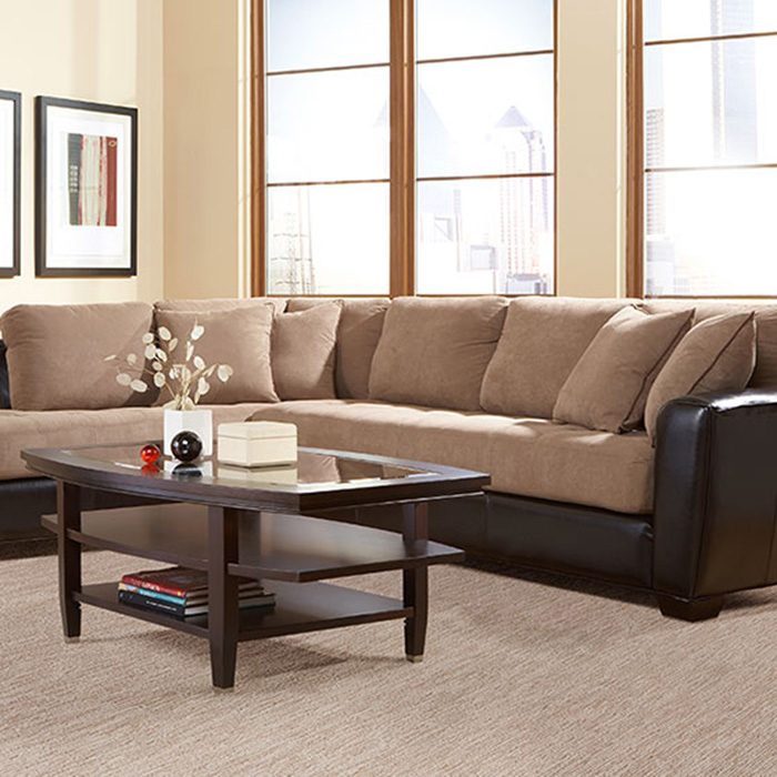 Living room with soft neutral carpet and a sectional sofa